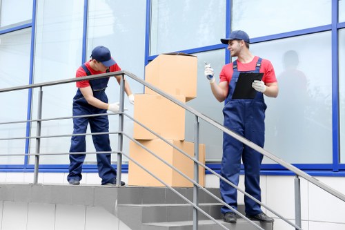 Removal company team loading boxes into a moving van