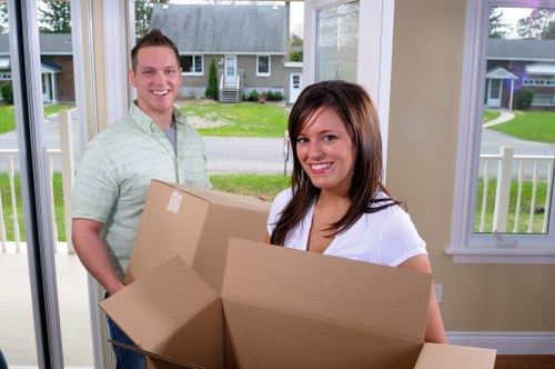 Professional movers handling furniture and packing in a busy London street