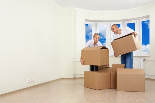 Removalists carrying furniture through a narrow staircase