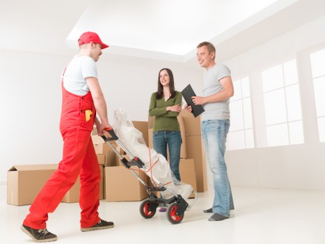 Local Shoreditch movers lifting office furniture during relocation