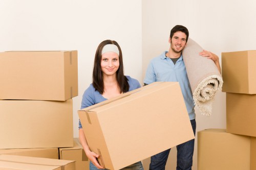 Trained movers handling furniture with care during a house move