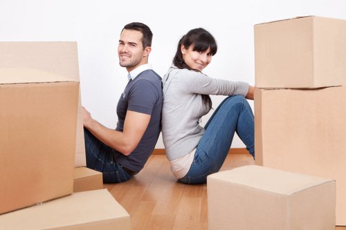 Movers handling office equipment in an East London building